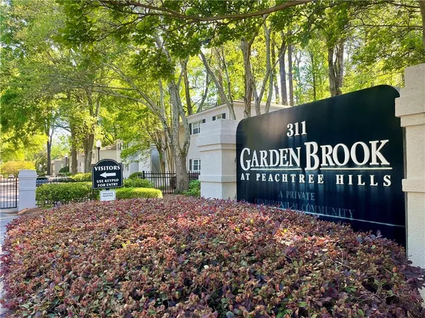 a front view of a house with a yard and a garage