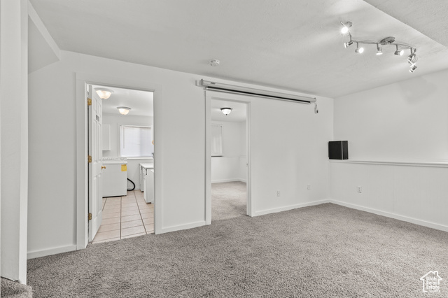 1099 Three Point Avenue Logan, UT 84321 - Photo 17 of 27 Empty room with light colored carpet and light tile patterned floors