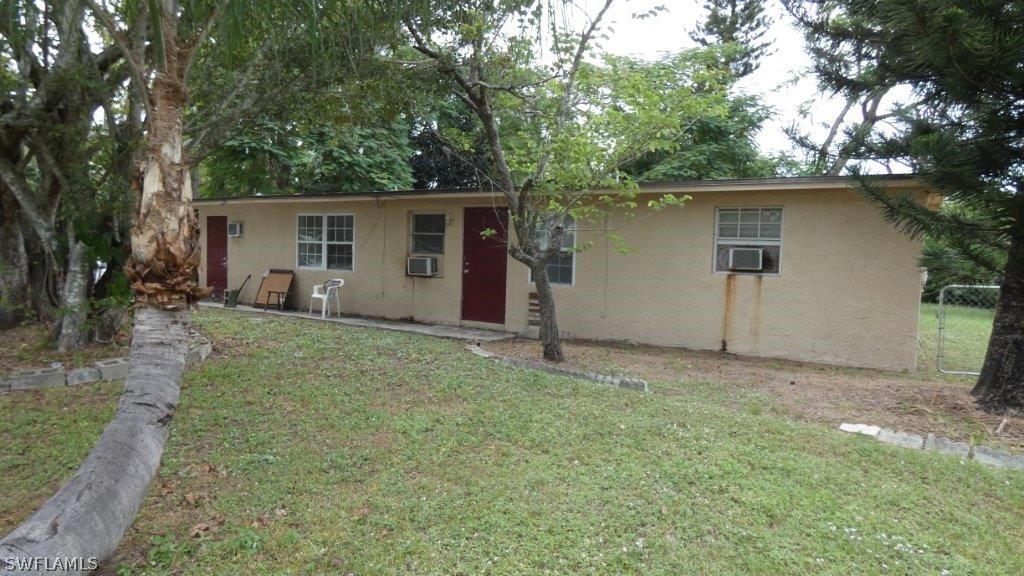4519 Luckett Road Fort Myers, FL 33905 - Photo 1 of 26 front view of house with a yard and trees all around
