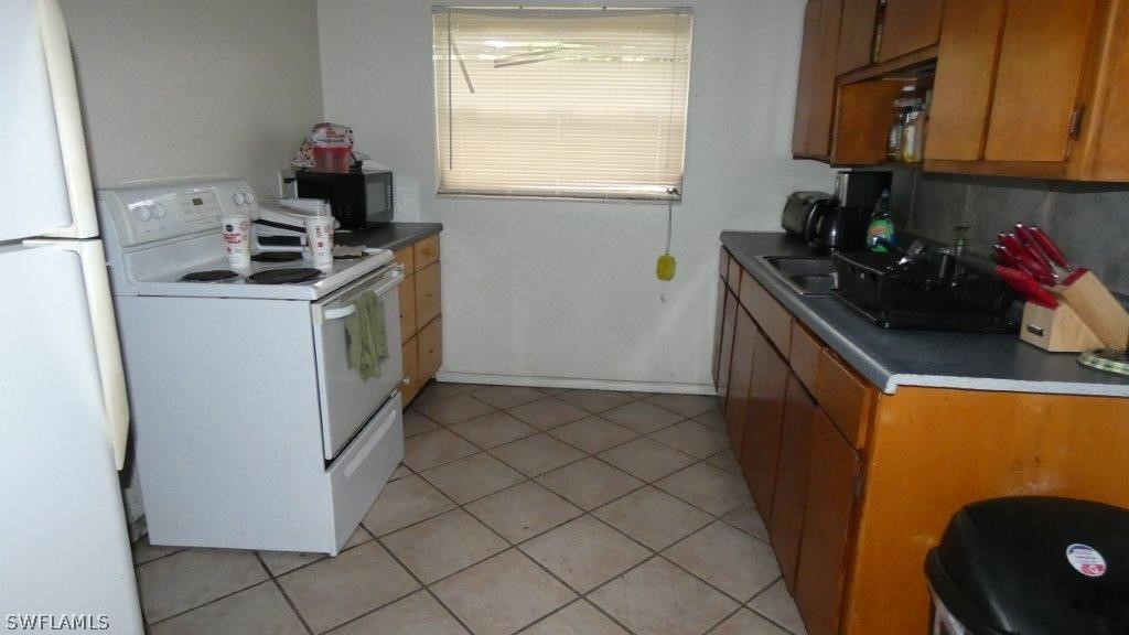 4519 Luckett Road Fort Myers, FL 33905 - Photo 20 of 26 a kitchen with a sink a stove and cabinets