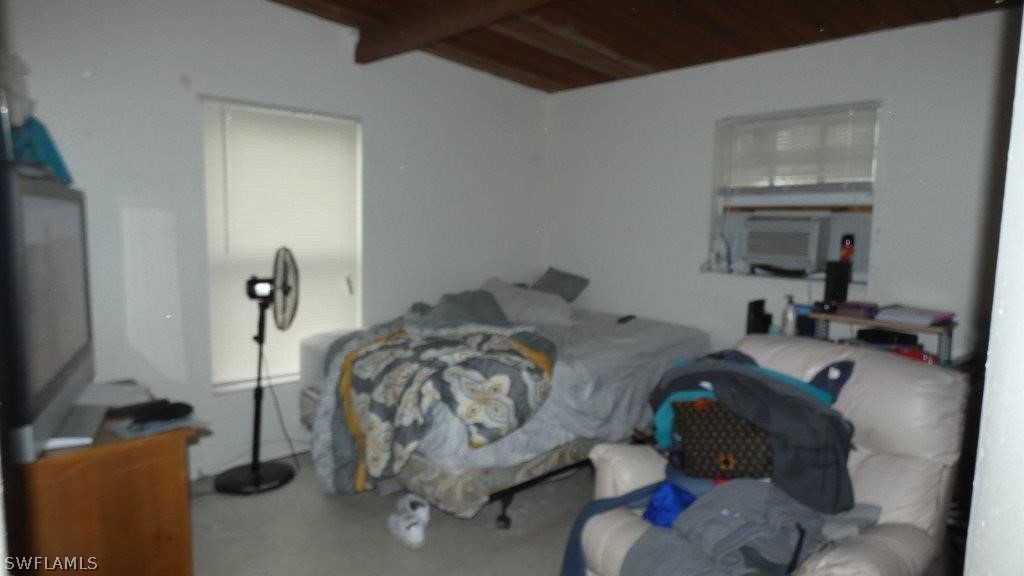 4519 Luckett Road Fort Myers, FL 33905 - Photo 23 of 26 a bedroom with a bed and a flat tv screen
