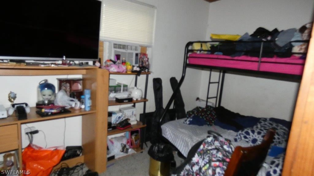 4519 Luckett Road Fort Myers, FL 33905 - Photo 24 of 26 a bed room with a bed and a television