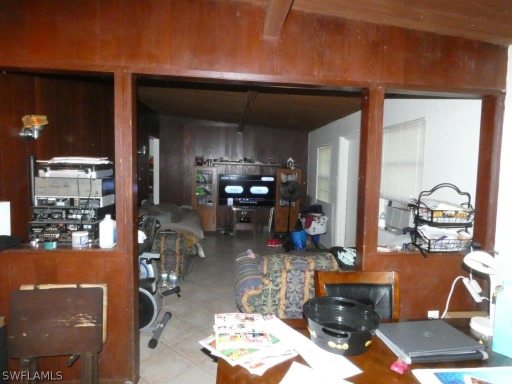 4519 Luckett Road Fort Myers, FL 33905 - Photo 4 of 26 a living room with furniture and a dining table with kitchen view