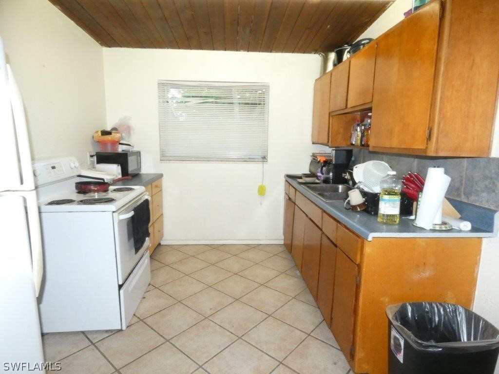 4519 Luckett Road Fort Myers, FL 33905 - Photo 6 of 26 a kitchen with a sink stove and cabinets