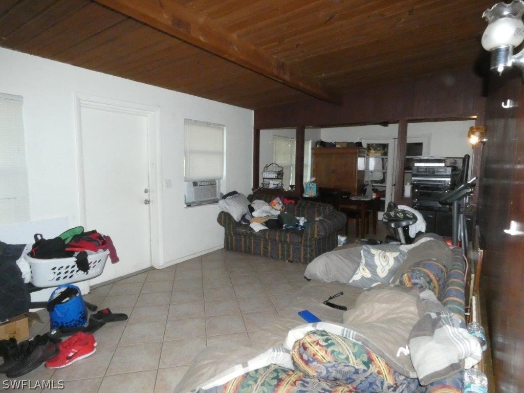4519 Luckett Road Fort Myers, FL 33905 - Photo 10 of 26 a living room with furniture a flat screen tv and gym equipment