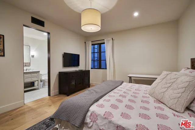 a green field with trees in the background