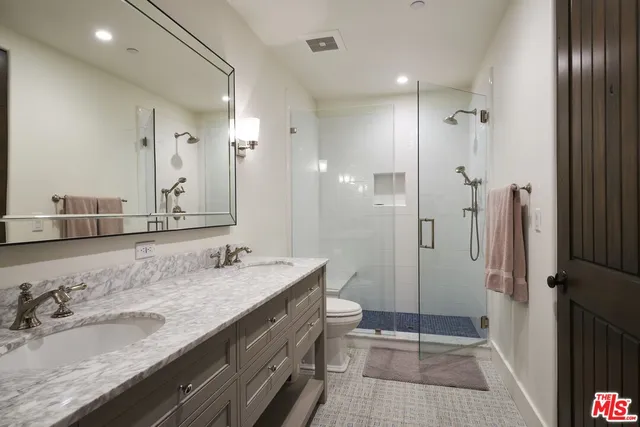a view of a patio with couches table and chairs and potted plants