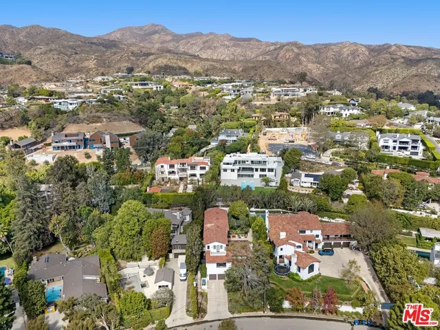 a living room with furniture a rug and white walls