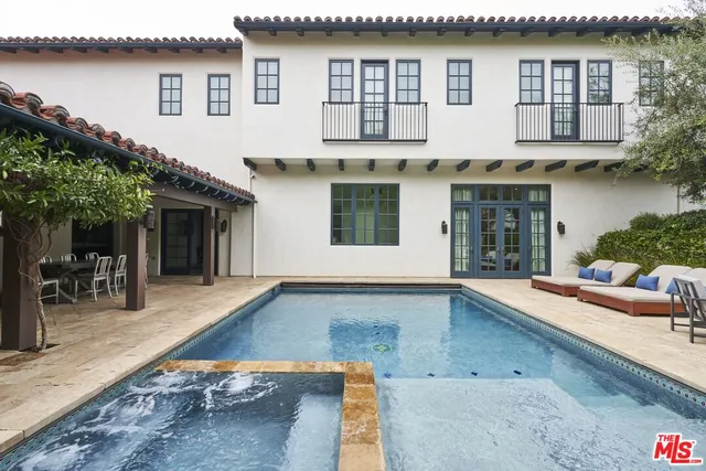 a large white kitchen with a large stove a sink dishwasher and a stove with wooden floor