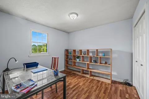 a workspace with furniture window and wooden floor