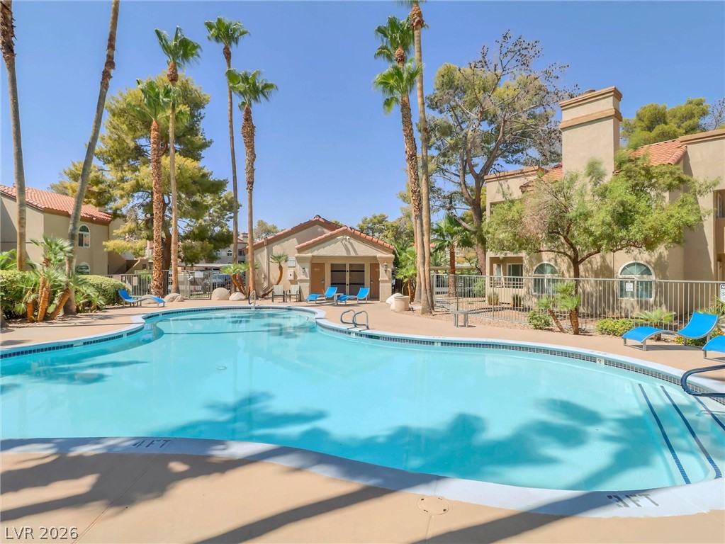 3145 East Flamingo Road, Unit 2129 Las Vegas, NV 89121 - Photo 39 of 43 Palm-lined poolside oasis offers a perfect escape.
