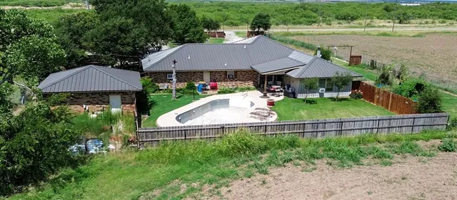 a view of house with garden and outdoor seating
