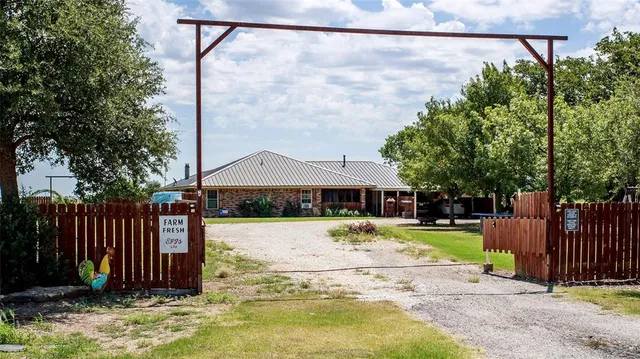 a view of a house with a yard and tree s