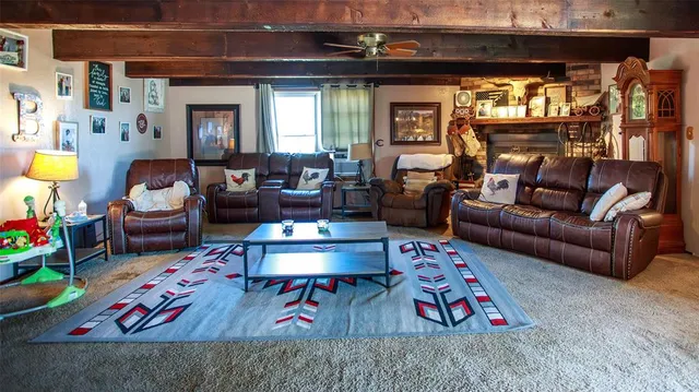 a living room with patio furniture and a floor to ceiling window