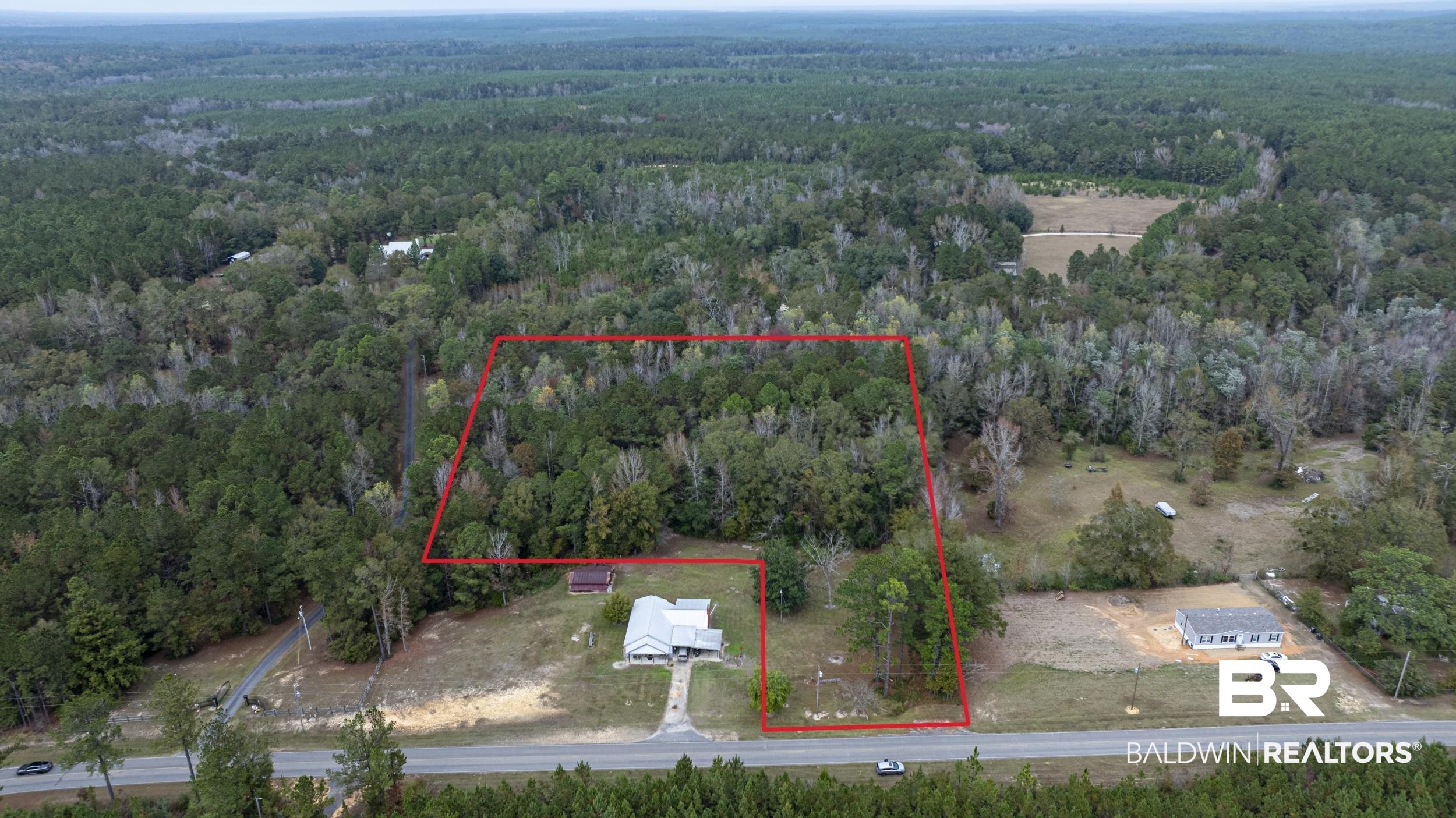 11753 Maytower Road Stockton, AL 36579 - Photo 2 of 8 Aerial view of property and surrounding area featuring property boundaries highlighted and a heavily wooded area