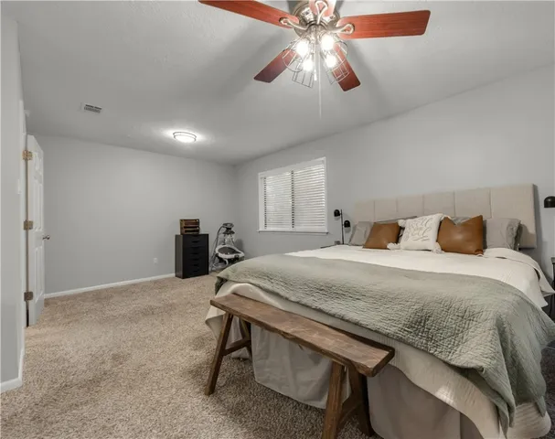 a bedroom with a bed and a chandelier