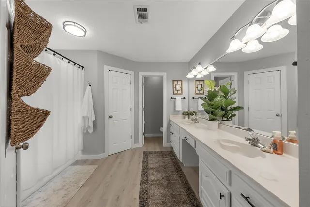 a spacious bathroom with a double vanity sink and a mirror
