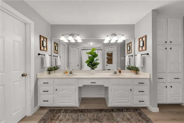 a spacious bathroom with a granite countertop sink a mirror and a