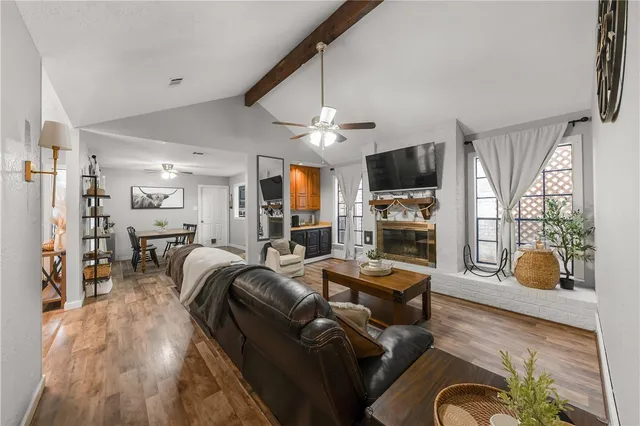a living room with fireplace furniture and a flat screen tv