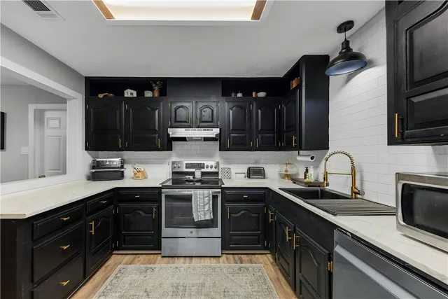 a kitchen with a sink and cabinets