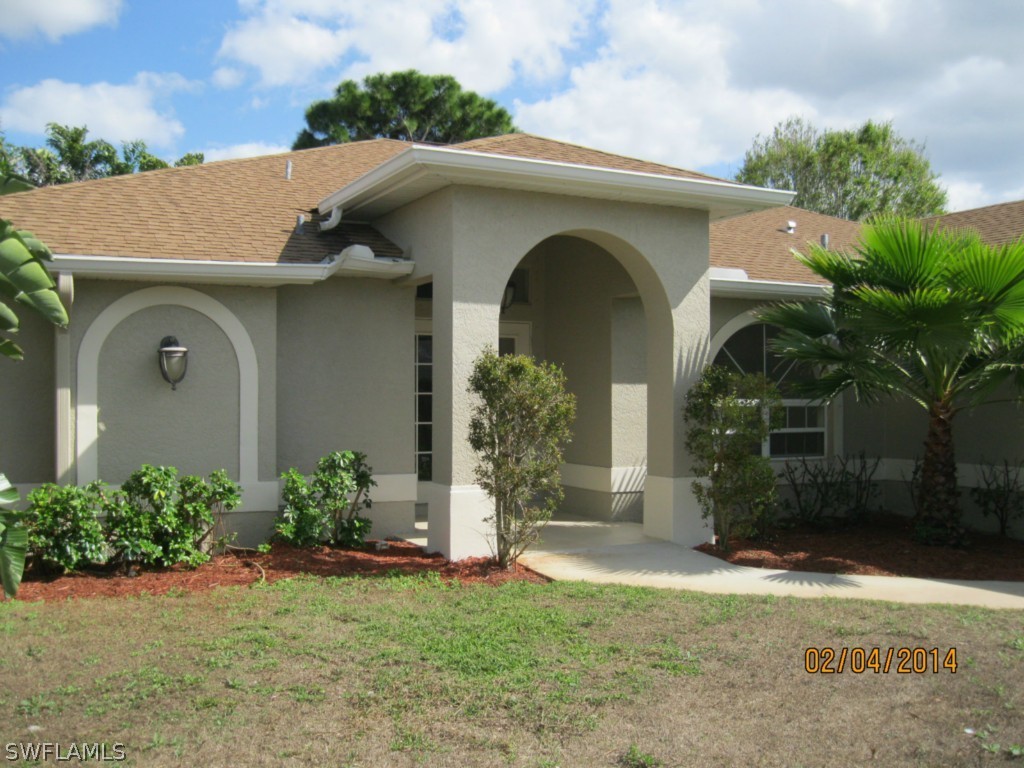 18225 Fuchsia Road Fort Myers, FL 33967 - Photo 1 of 23 a front view of a house with garden