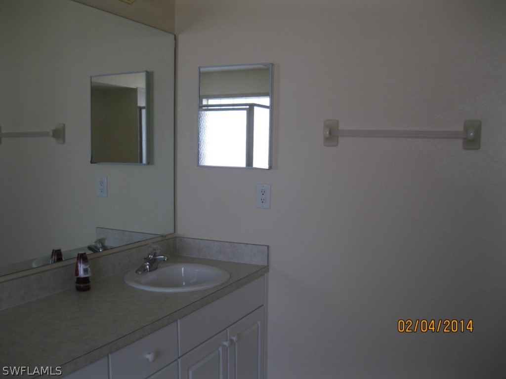 18225 Fuchsia Road Fort Myers, FL 33967 - Photo 14 of 23 a bathroom with a sink and a mirror