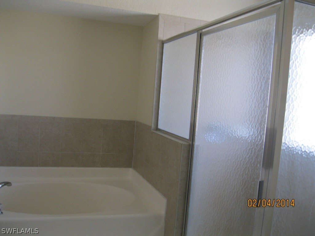 18225 Fuchsia Road Fort Myers, FL 33967 - Photo 16 of 23 a bathroom with a bathtub