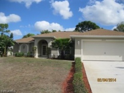 18225 Fuchsia Road Fort Myers, FL 33967 - Photo 3 of 23 a front view of a house with a garden