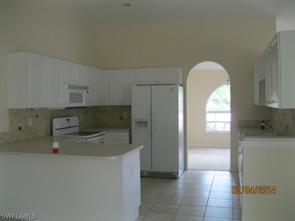 18225 Fuchsia Road Fort Myers, FL 33967 - Photo 7 of 23 a kitchen with stainless steel appliances a refrigerator and a sink