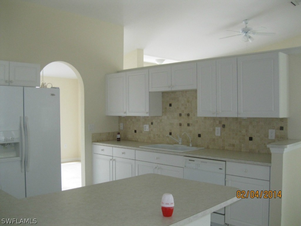 18225 Fuchsia Road Fort Myers, FL 33967 - Photo 8 of 23 a kitchen with a sink and cabinets