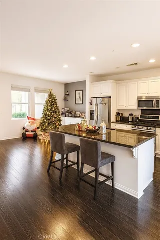 a kitchen with a table chairs stove and cabinets