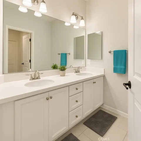 a bathroom with a double vanity sink mirror and