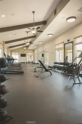 a living room with lots of furniture and gym equipment