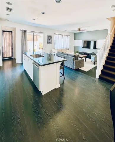 a kitchen with stainless steel appliances kitchen island granite countertop a stove and a sink