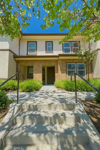 a view of a brick house with a yard