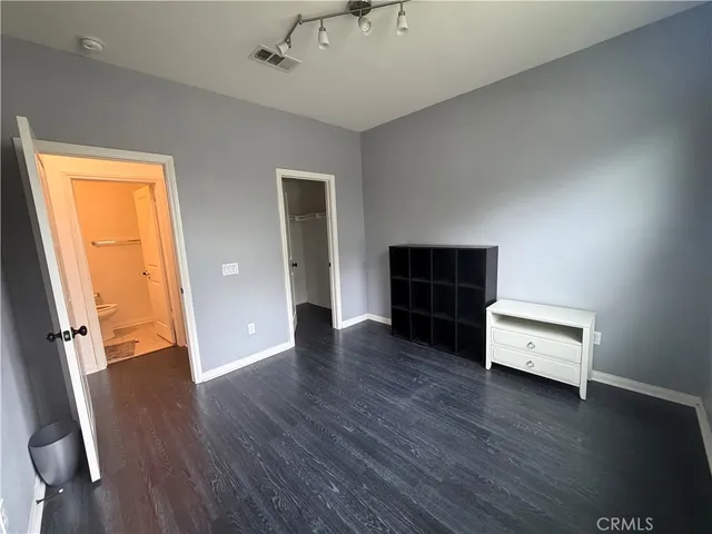 an empty room with furniture and wooden floor