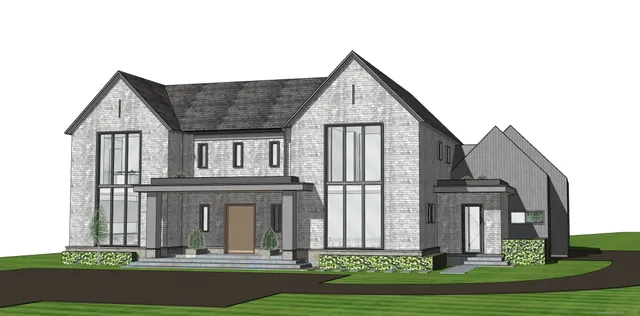 a view of a brick house with a yard plants and large tree