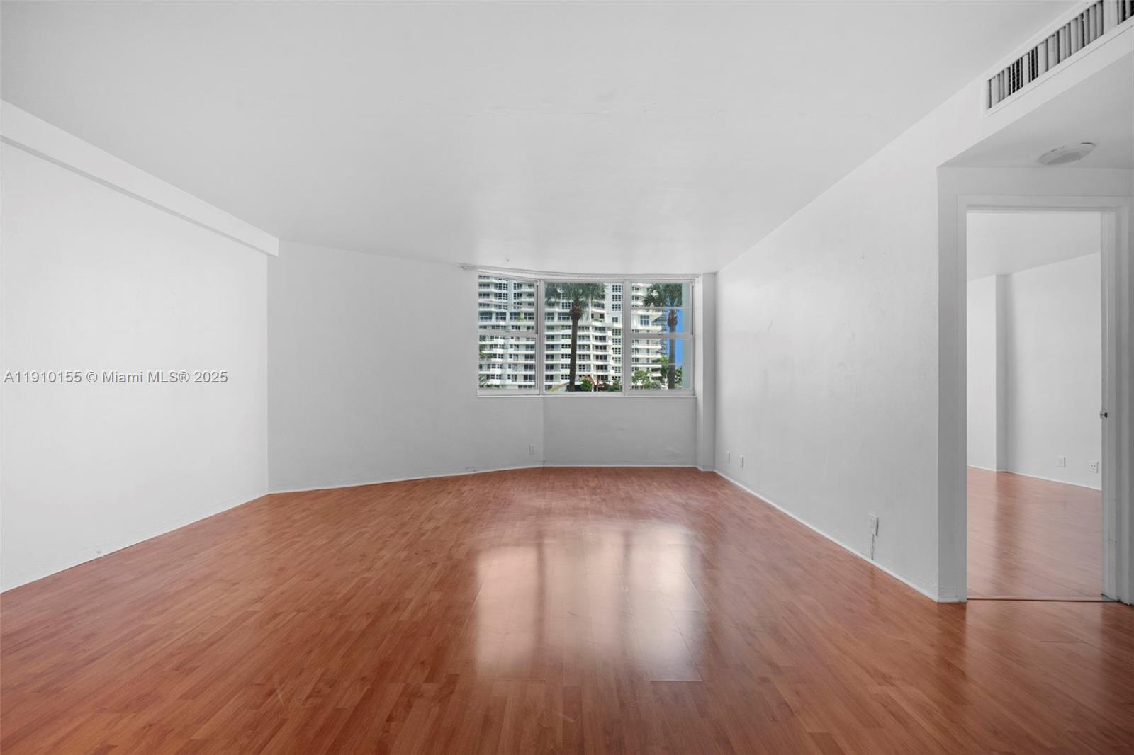 3301 Northeast 5th Avenue, Unit 214 Miami, FL 33137 - Photo 16 of 23 an empty room with wooden floor and windows