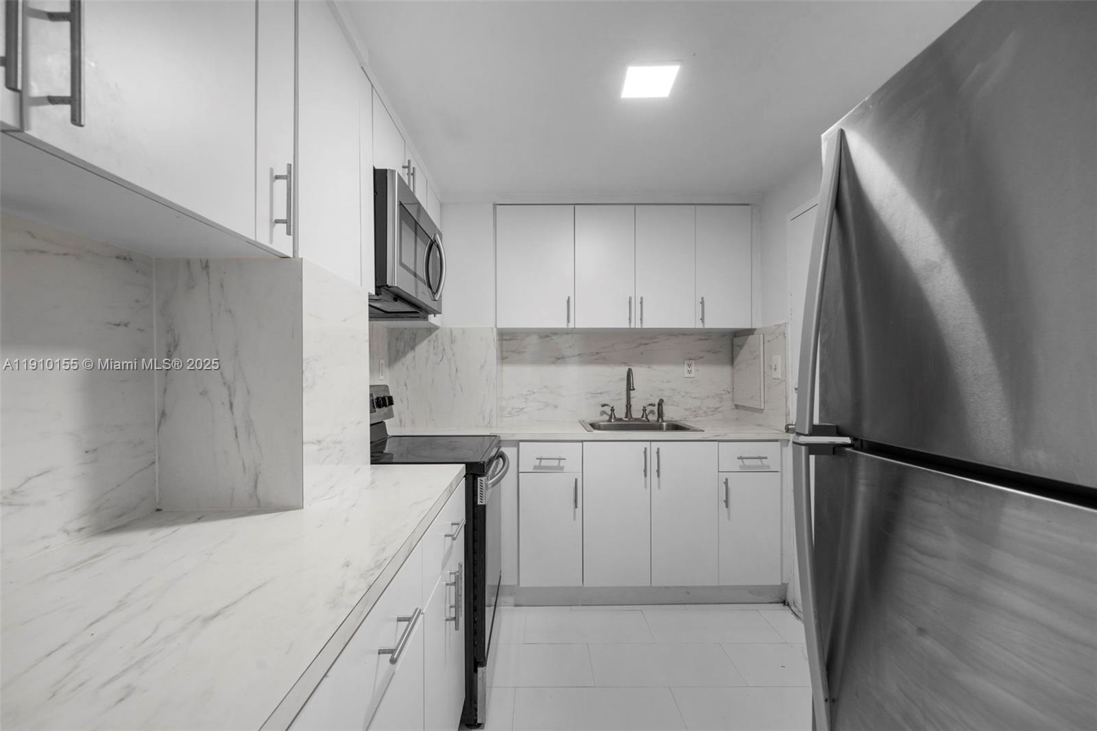 3301 Northeast 5th Avenue, Unit 214 Miami, FL 33137 - Photo 17 of 23 a kitchen with stainless steel appliances a refrigerator sink and cabinets