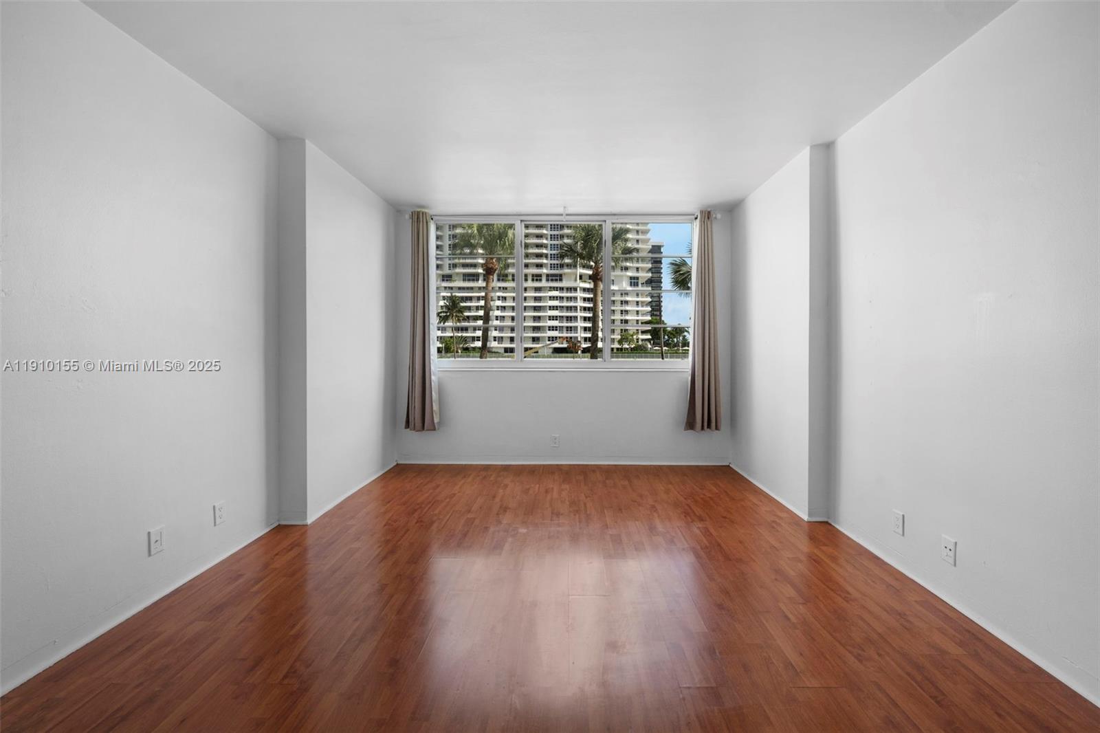 3301 Northeast 5th Avenue, Unit 214 Miami, FL 33137 - Photo 20 of 23 an empty room with wooden floor and windows