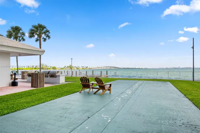 a view of a swimming pool with a lounge chair and tables