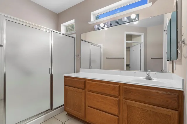 a bathroom with a double vanity sink and mirror