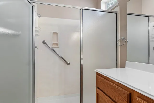 a bathroom with a shower and a sink