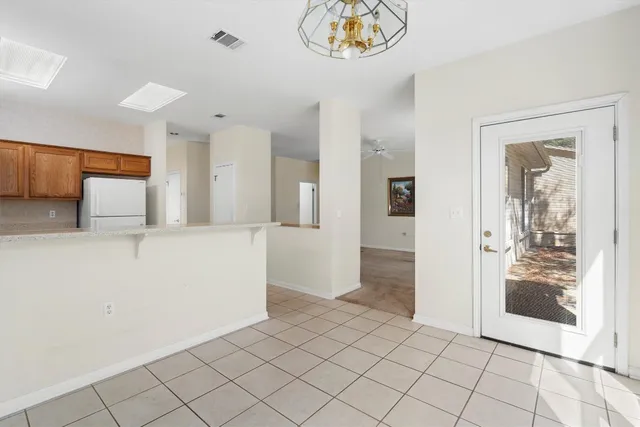 a view of a room with wooden floor and cabinet