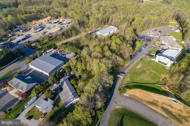 an aerial view of a house with a yard and lake view