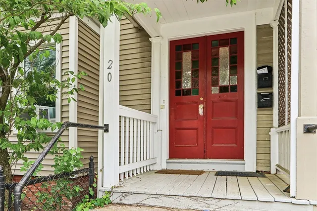 a view of a house with a door and wooden floor