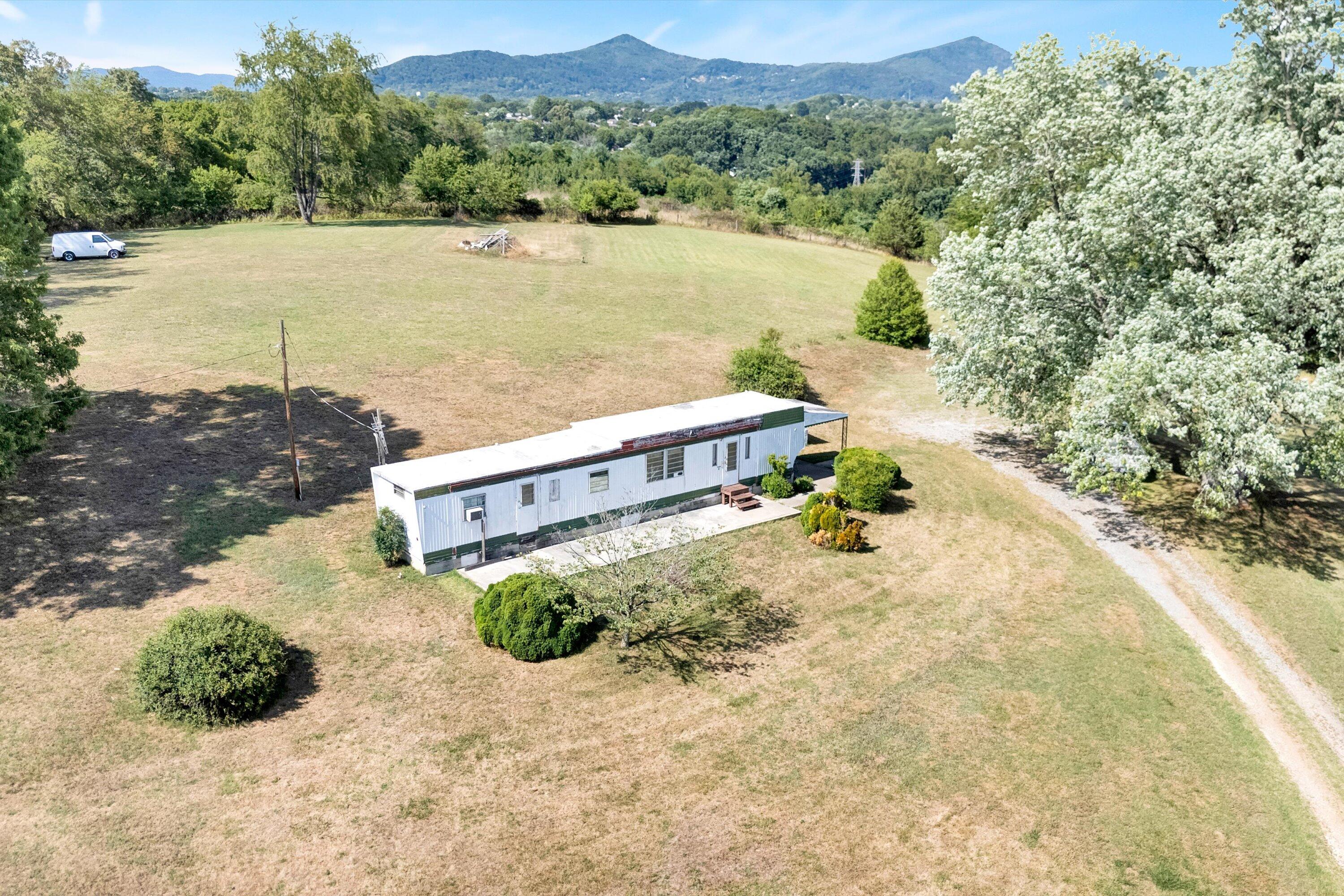 2744 Highland Road Roanoke, VA 24014 - Photo 3 of 29 a view of a lake with a mountain in the background