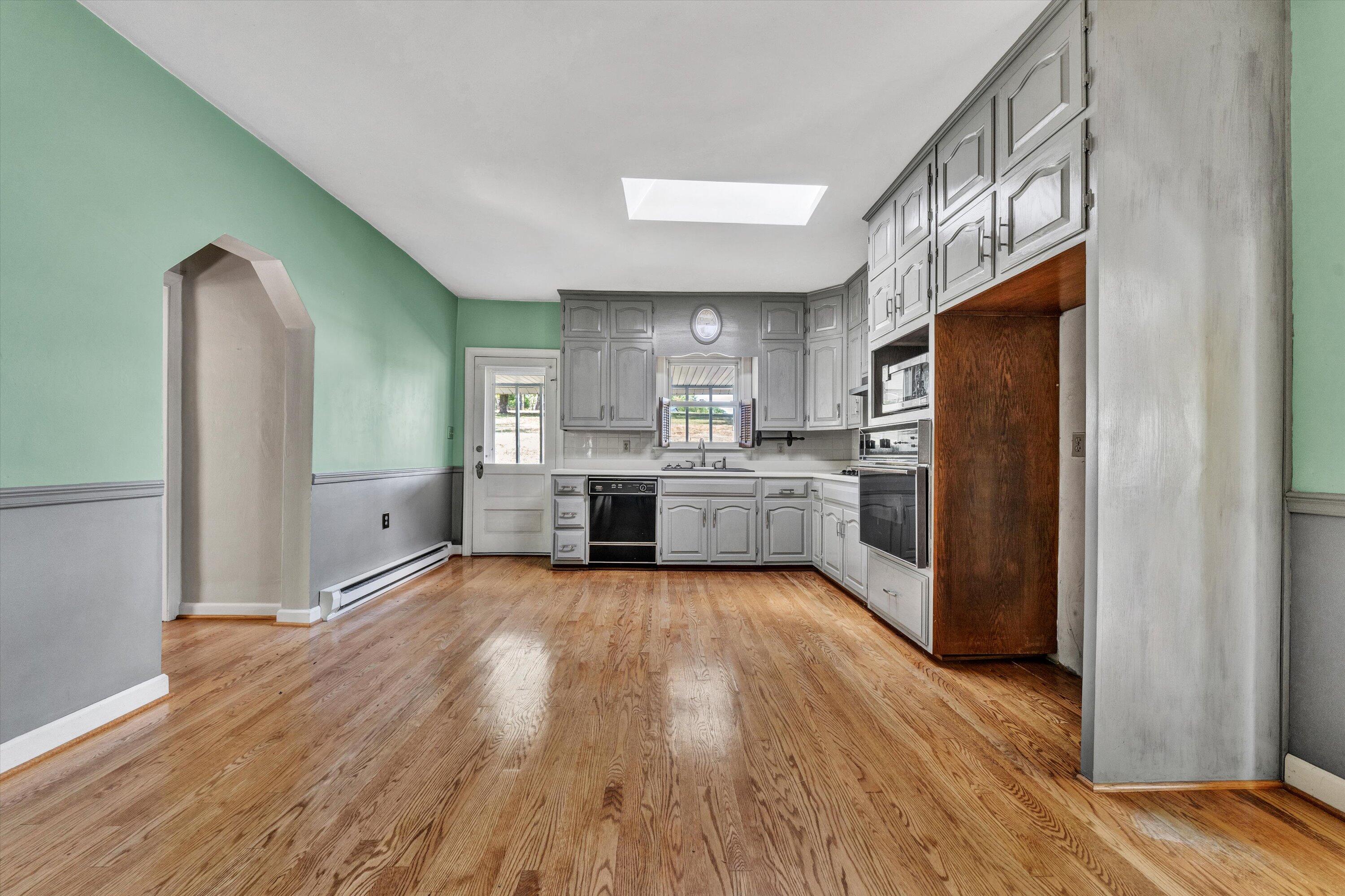 2744 Highland Road Roanoke, VA 24014 - Photo 8 of 29 a large kitchen with cabinets and wooden floor