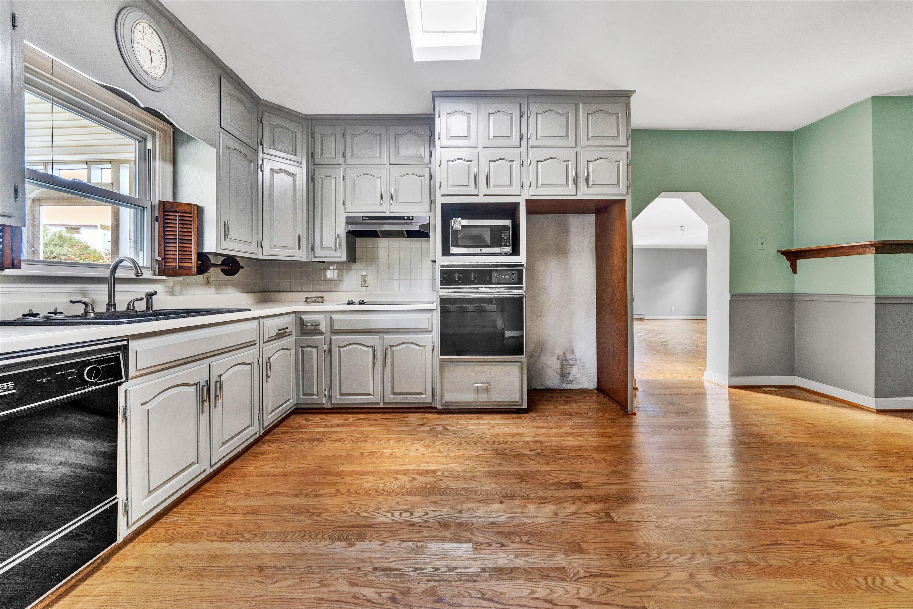 2744 Highland Road Roanoke, VA 24014 - Photo 9 of 29 a large kitchen with stainless steel appliances granite countertop a sink cabinets and a wooden floor