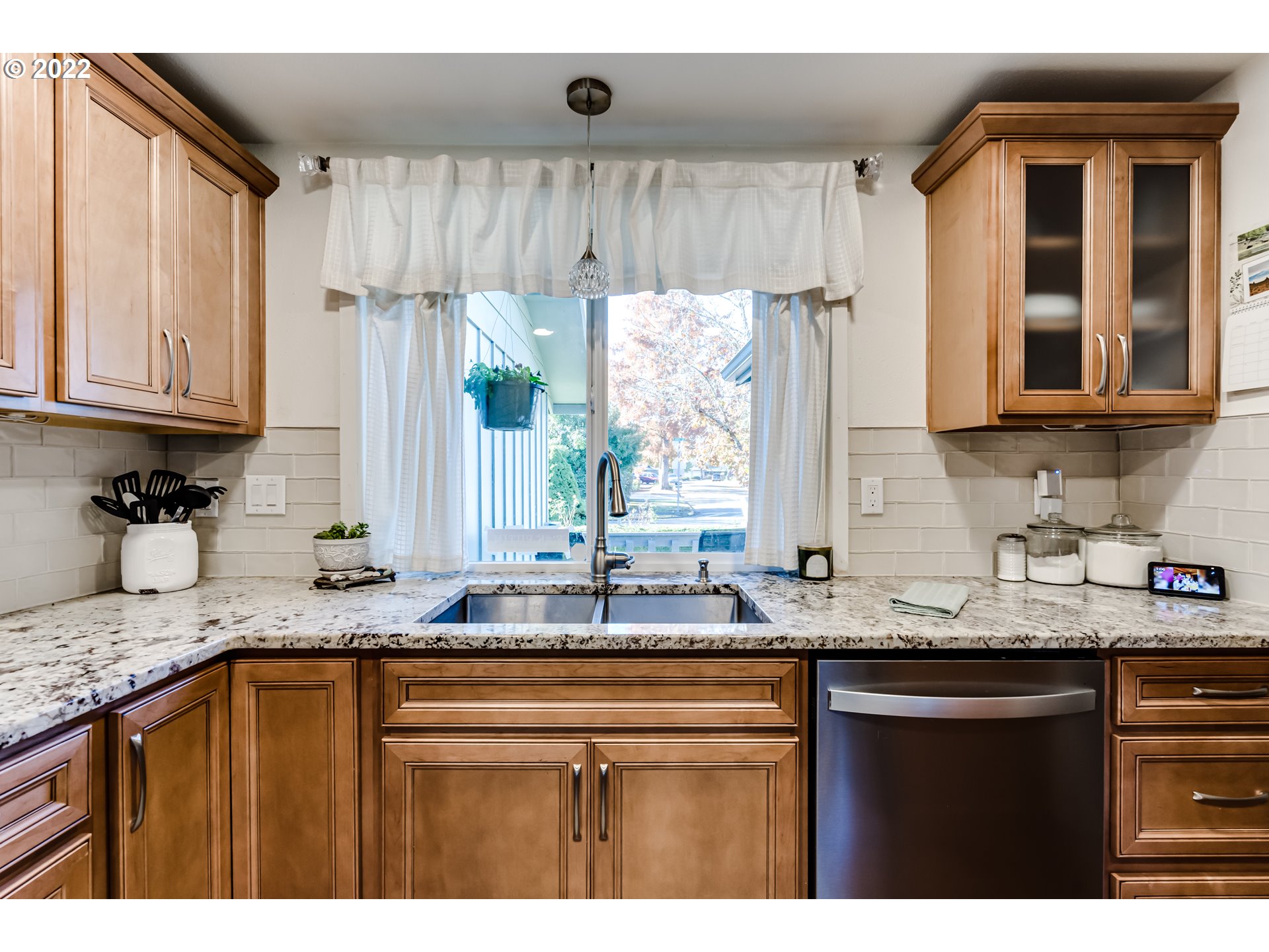 487 65th Street Springfield, OR 97478 - Photo 5 of 20 a kitchen with granite countertop a sink stove and cabinets
